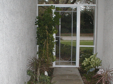 Front door entry way lined with plants.