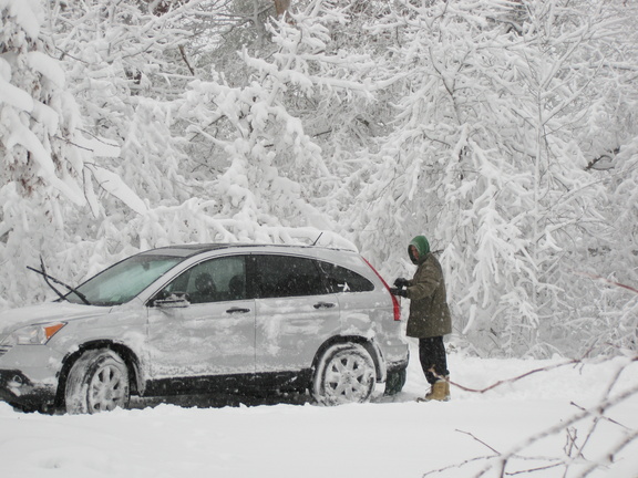 Steve's trying to get the car cleaned off to leave, but the snow keeps falling.